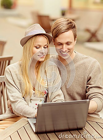 Couple with laptop in cafe