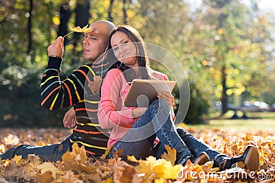 Couple Listening To Music On Autumn Leaves