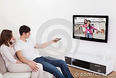 Couple in livingroom watching television