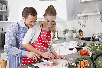 Couple in love cooking together in the kitchen and have fun