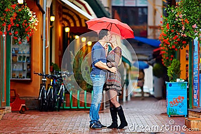 Couple in love kissing under the rain