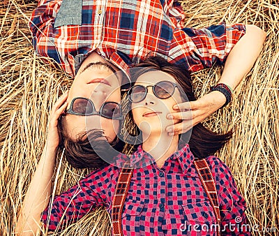 Couple in love is lying on the dry grass