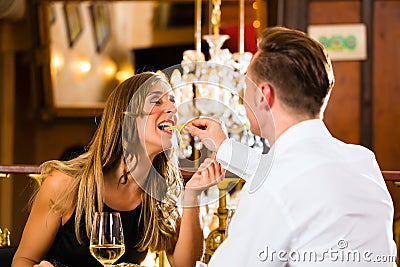 Happy couple in restaurant eat fast food