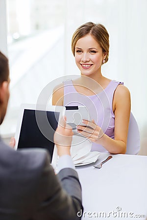 Couple with menus on tablet pc at restaurant