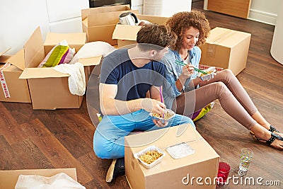 Couple Moving Into New Home Enjoying Takeaway Meal