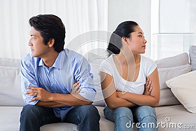 Couple not talking after a dispute on the sofa