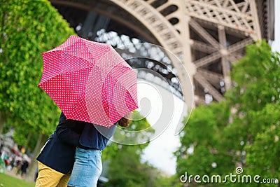 Couple in Paris kissing under rain