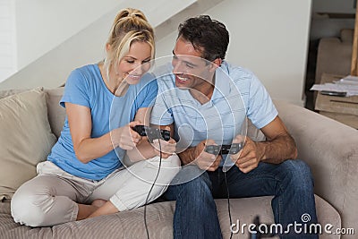 Couple playing video games in living room