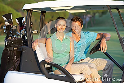 Couple Riding In Golf Buggy