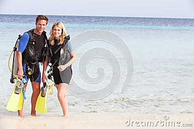 Couple With Scuba Diving Equipment Enjoying Beach Holiday