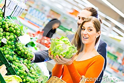 Couple shopping groceries in supermarket