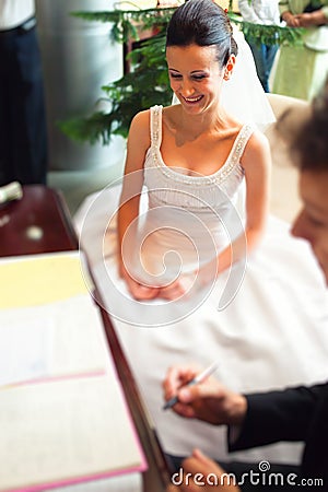 Couple signing wedding papers