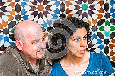 Couple sitting with Arabic mosaic