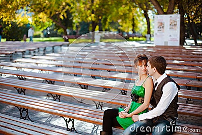 Couple Sitting Together On Park Bench