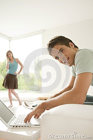 Couple Smiling at Home with Technology