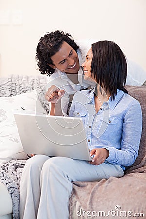 Couple surfing the internet on the sofa