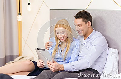 Couple with tablet pc computer in hotel room