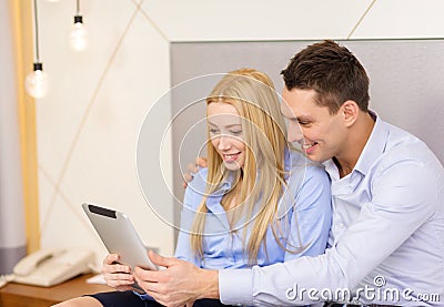 Couple with tablet pc computer in hotel room