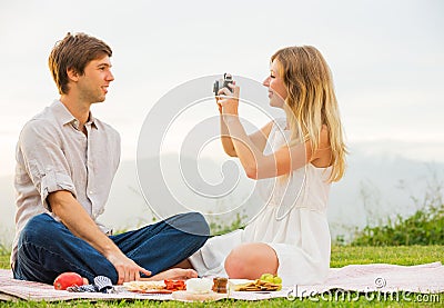 Couple taking photos of each other with retro vintage camera on