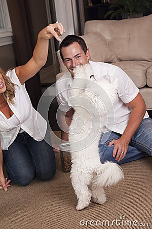 Couple teaching dog tricks