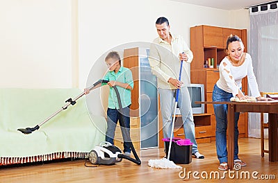 Couple with teenage son doing house cleaning