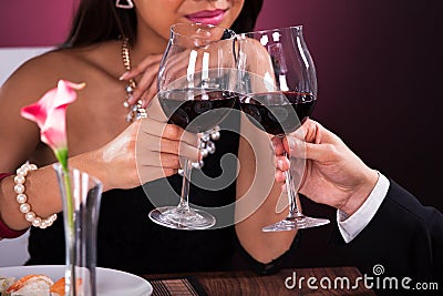 Couple toasting wineglasses in restaurant