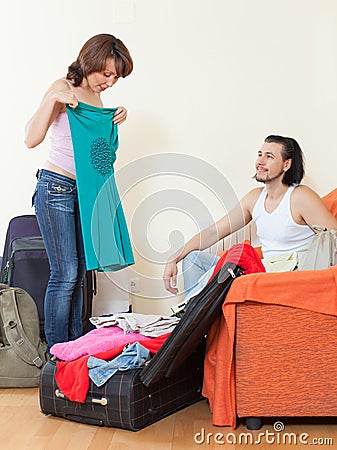 Couple together choosing clothes for vacation