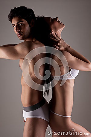 Couple In Underwear Standing Back To Back