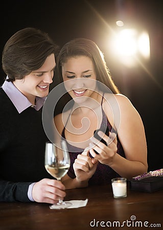 Couple Using Smart Phone In Night Club