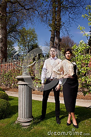 Couple in Victorian clothing, pillar and sundial i