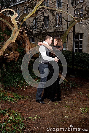Couple in Victorian clothing embracing in the park