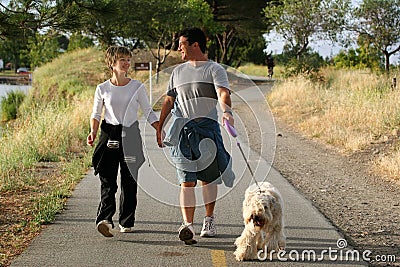 Couple walking their dog