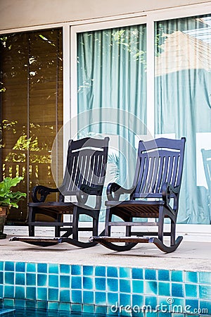 Couple wooden arm chairs for relaxing