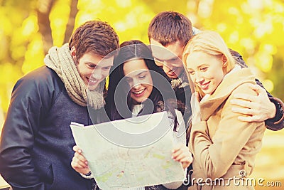 Couples with tourist map in autumn park