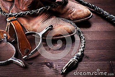 Cowboy boots,whip and spurs on wood