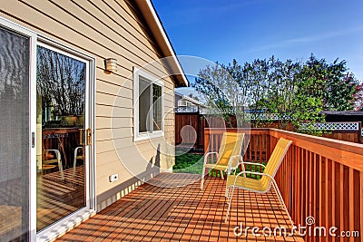 Cozy small backyard with wooden walkout deck