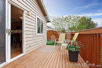 Cozy small backyard with wooden walkout deck