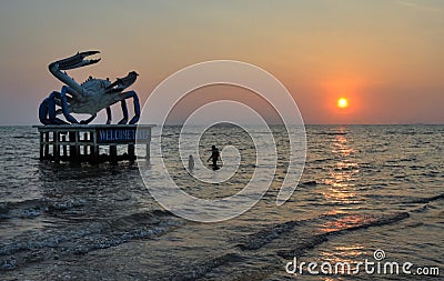 Crab statue and swimmers at Kep Beach