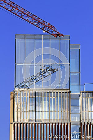 Crane with mirror glass skyscraper