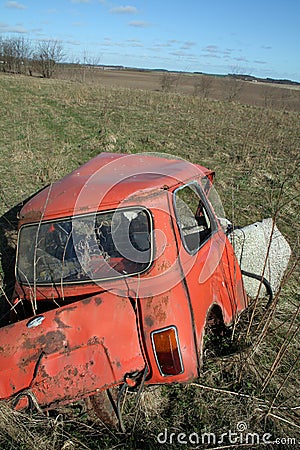 Crashed car in field