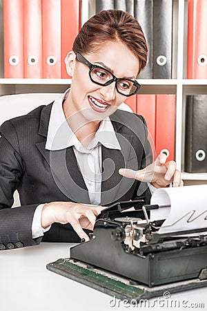 Crazy business woman working with typewriter