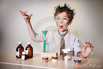 Crazy scientist. Young boy performing experiments