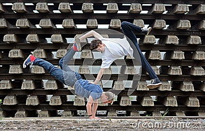 Crazy teenagers dancing break dance on the rails