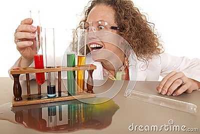 Crazy woman scientist with test tubes grab red