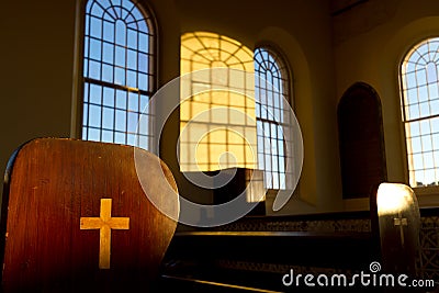 Cross on end of pew in historic chapel