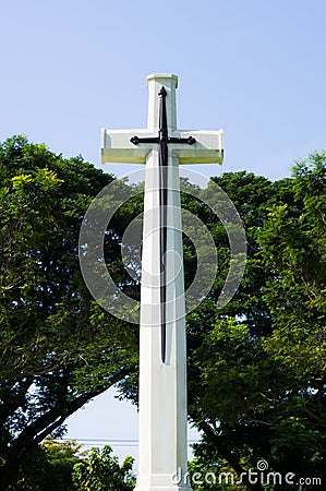 Cross with green trees