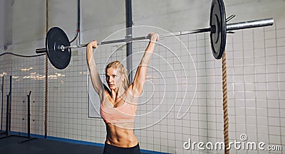 Crossfit woman lifting weights