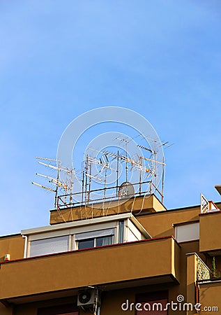 Crowd of antennas on the roof