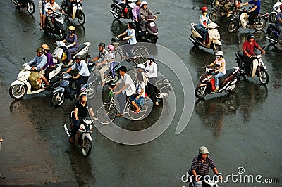 Crowd of people ride motorcycle in rush hour