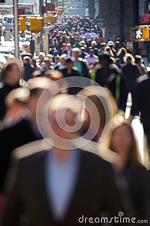 Crowd of people walking on city street